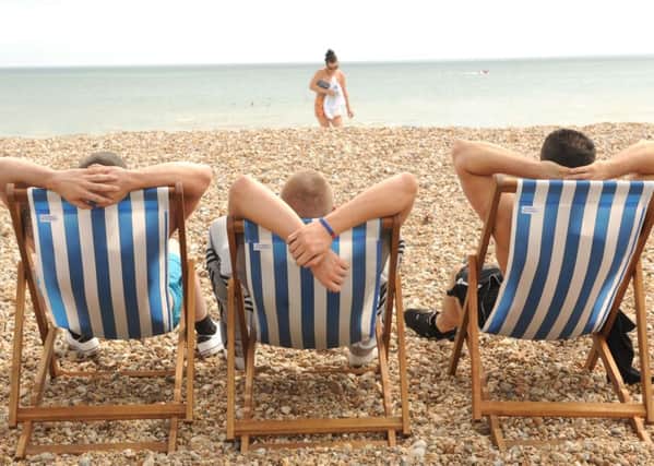 Lads, just being lads!  - Relaxing on Bognor beach.  Picture by Louise Adams C131001-2 Bog Hot Weather ENGSUS00120130722140100