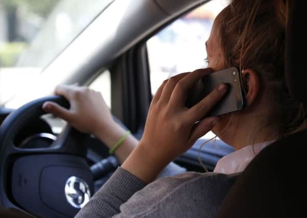 Embargoed to 0001 Monday October 19
PICTURE POSED BY MODEL 
File photo dated 13/08/14 of a woman talking on her phone while driving. Prosecutions for motorists using a phone at the wheel are down by almost half in five years despite a study showing the potentially dangerous practice is more common, official figures show. PRESS ASSOCIATION Photo. Issue date: Monday October 19, 2015. Data released by the Ministry of Justice last month show that just 17,414 prosecutions for drivers using their phone at the wheel were launched in magistrates' courts in England and Wales last year, down by 47% from 32,571 in 2009. See PA story TRANSPORT Phone. Photo credit should read: Jonathan Brady/PA Wire PPP-151018-181249001