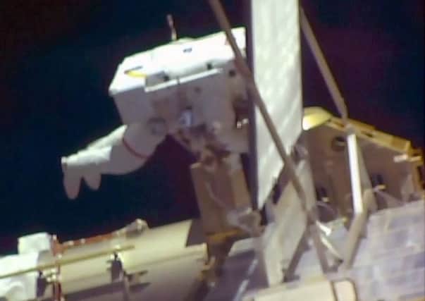 Tim Peake is tethered to the space station during the work