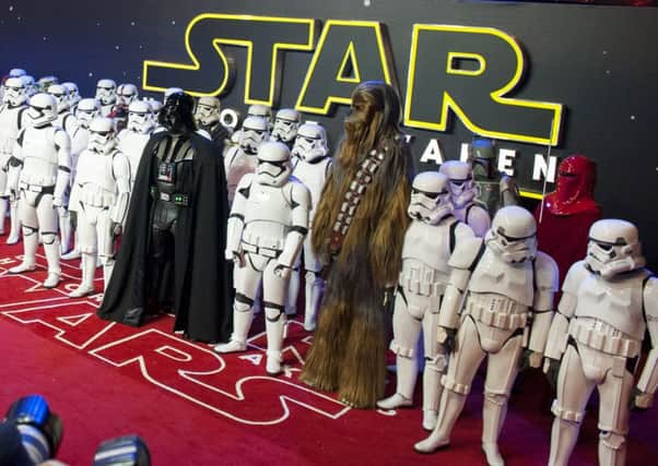 A full cast of stormtroopers, Darth Vader and Chewbacca at the European premiere of Star Wars: The Force Awakens, in Leicester Square, central London, on Thursday, December 16, 2015. See SWNS story SWSTARSWARS; The Star Wars cast and crew arrived in Britain in style yesterday (Weds) inside a luxury plane - decked-out like R2D2. The ANA 787 may not have made the Kessel Run in less than 2 parsecs, but it did safely deliver the stars of the most anticipated film of all time to Gatwick Airport ahead of the largest European movie premiere ever. Stars including Harrison Ford, Mark Hamill and John Boyega travelled aboard the blue and white plane from LA, and were accompanied by a normal-sized version of beloved astromech droid R2D2. Also on board was creator George Lucas as well as the director of the newest film, J J Abrams. SUS-160801-114418001