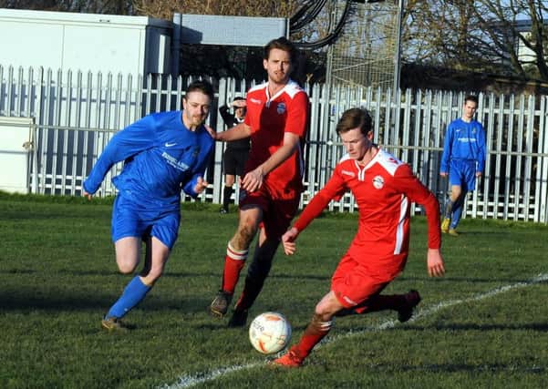 Mark Thompson (blue shirt) chases possession for Selsey against Crawley Down Gatwick / Picture by Kate Shemilt