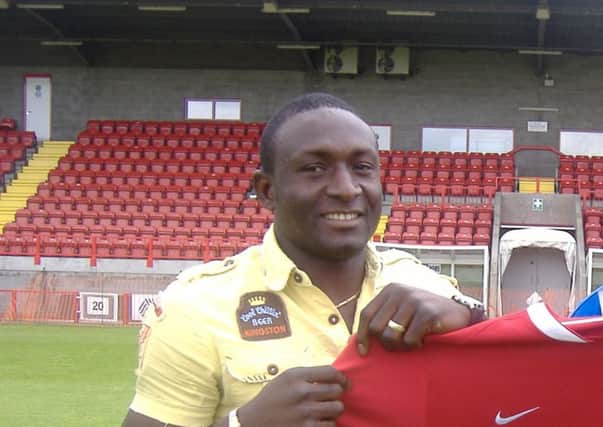 Guy Madjo (left) pictured signing for Crawley in 2007
