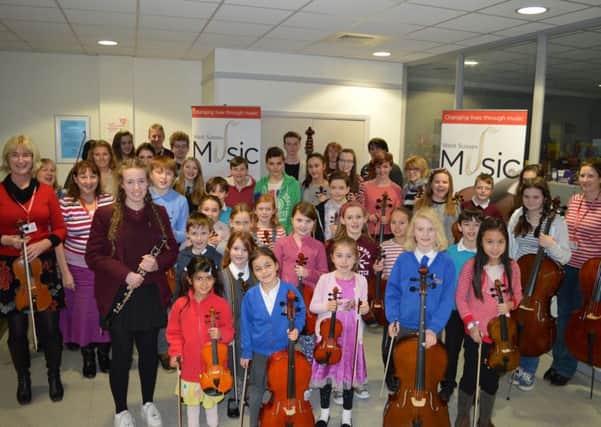 Young musicians, aged six to 18, from Worthing Music Centre with their teachers, enjoying a break between rehearsals