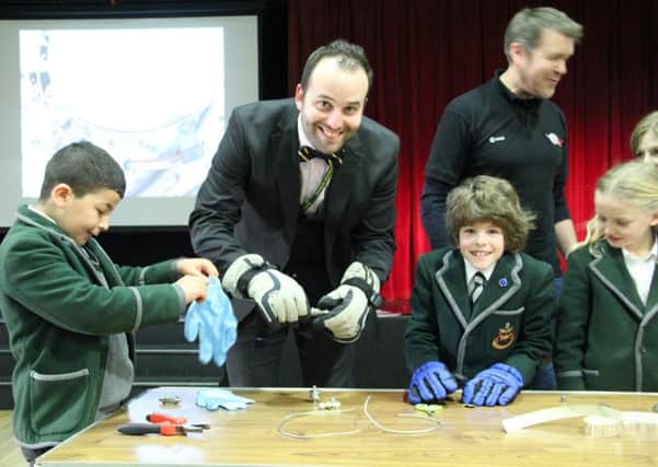 Oakwood School staff and pupils have a go at working in thick gloves