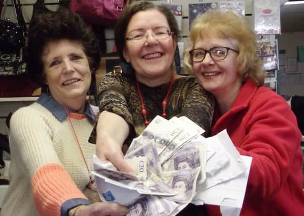 Assistant manager Janet Dawkins, manager Jane Davies and volunteer Debbie Hughes with some Â£20s