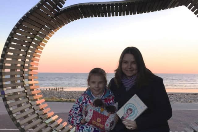 Authors Carol Thomas and daughter Emily, with Bobby, the mascot that inspired her short story