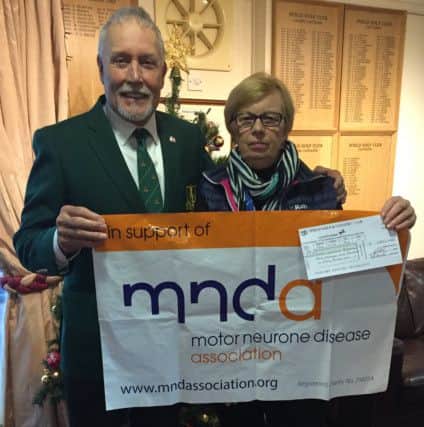 Ifield Golf Club's Bob Hazlewood presenting a cheque to Pam Fry of MND SUS-160118-154750002