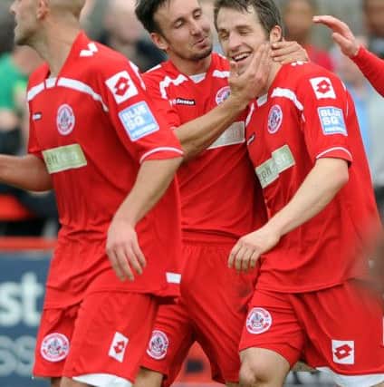 Ben Smith is congratulated on his goal against Darlington that earned Crawley Town another three points and a step closer to becoming Champions of the Blue Sq Premier League. (Pic by Jon Rigby) ENGSNL00220110204210940