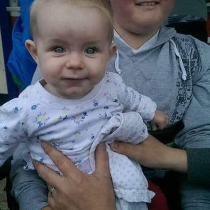 Kieron with his baby cousin Ava, who he adored, on his lap