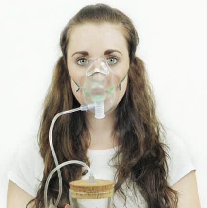 The second placed photo of a woman holding a plant while wearing a oxygen mask, modelled by Madeline Hetherington