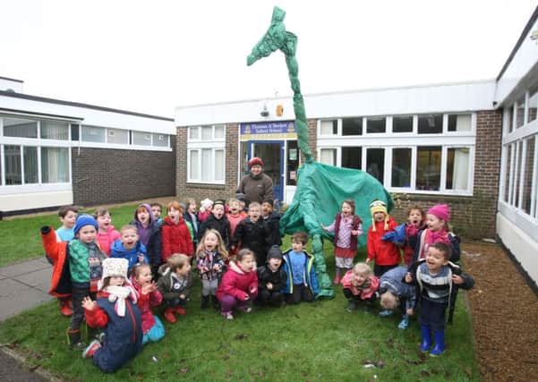 Forest School co-ordinator Sarah Wheal and pupils with the dinosaur at Thomas A'Becket Infant School. Photo by Derek Martin DM1612269a