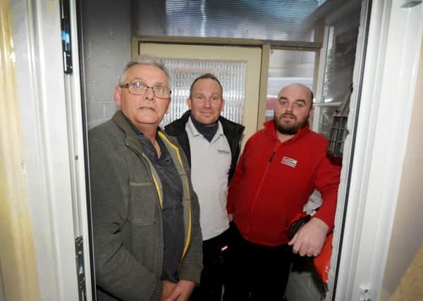 Team Frames's Joel Ufton (right) donating a new door with Harbour Home Improvements' Stuart Johnstone (centre) to Andy Dawson (left) in Bexhill.