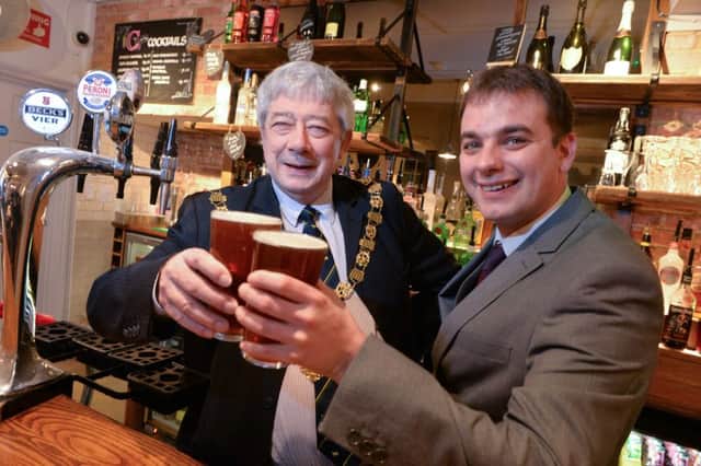 The Mayor of Chichester Peter Budge pulls the first pint at the new look Trents with general manager, Wayne Kent