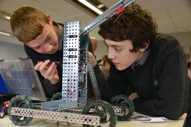 UTC@Harbourside Newhaven. Kyle Kneller (left) and Max Gilbert (right) constructing robots SUS-160128-102313001