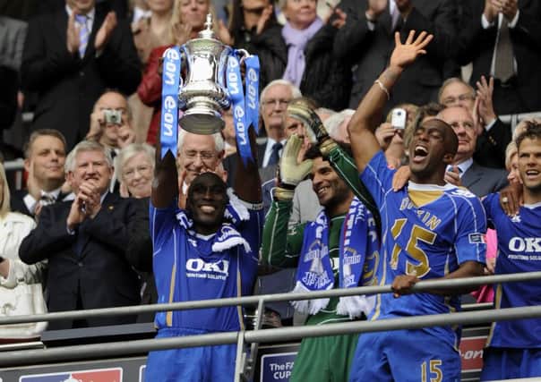 Sylvain Distin celebrates lifting the FA Cup with Pompey