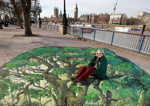Beccy Speight, chief executive, with the Woodland Trust's 3D artwork, wandering tree, on Londons South Bank