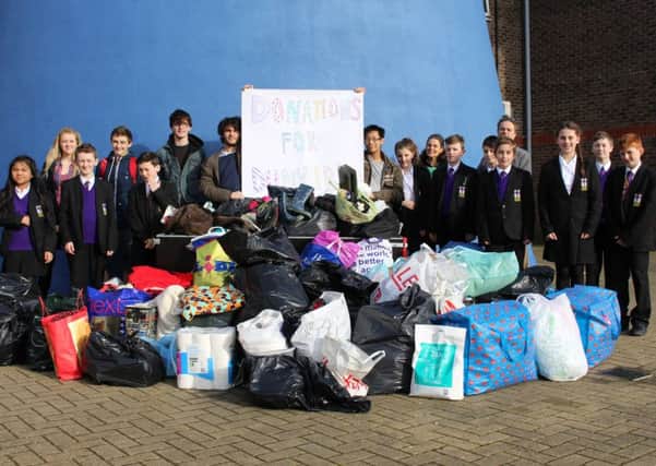 Students with parent Clare Stanton-Thompson present their donations to Martyn Allen SUS-160202-105922001