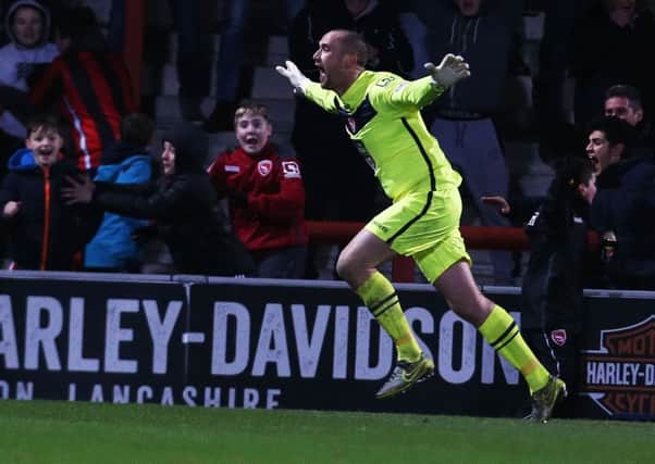 Morecambe keeper Barry Roche celebrates his goal against Pompey on Tuesday night Picture: Joe Pepler