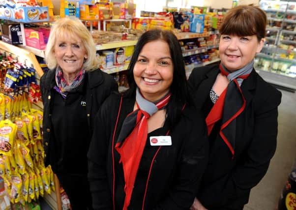 Jasminder Mangat, owns the post office and Premier store in North Road, Three Bridges. In February she will be celebrating 25 years running business. seen here with colleagues  Sue Wain (left), Maria Needham (right).  Pic Steve Robards  SR1605416 SUS-160219-162426001