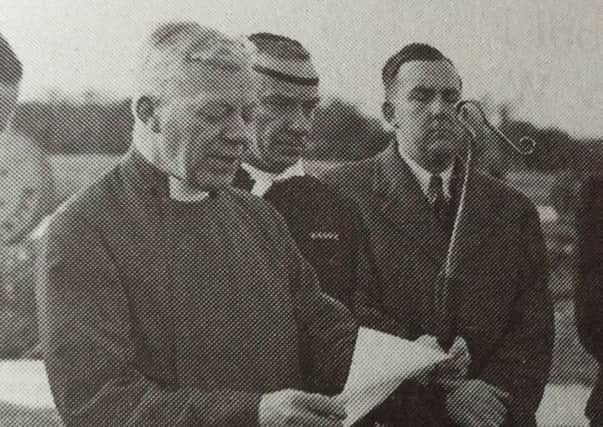 George Bell (centre holding a piece of paper)