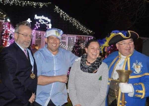 Worthing town crier Bob Smytherman and deputy mayor Sean McDonald at the switch on with Mark and Debbie Scott