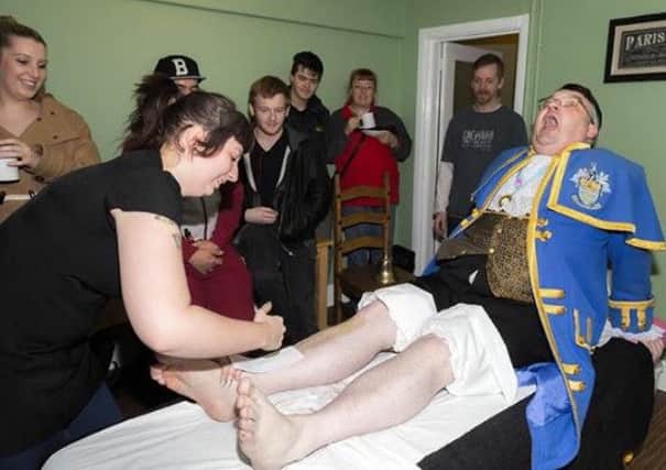 Worthing town crier Bob Smytherman has his legs waxed. PICTURES: BLUE DAWG