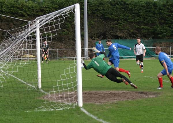 Horsham YMCA's Nick Sullivan (No.9) opens up the scoring for YM. Photo by Clive Turner