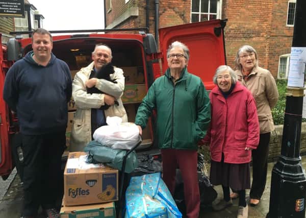 (L-R) Jon Crafer, Rev David Frost with with Sylvester the cat, John Lanigan, Janet Waddams and Sandra Lanigan with the van-full of donations