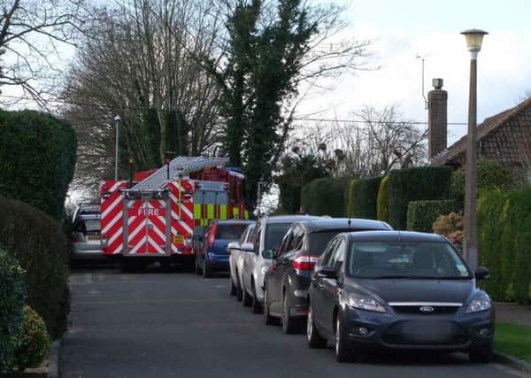 The fire engine was nearly blocked by parked cars