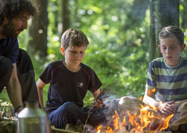 Children making a fire with a National Trust ranger. Picture: National Trust Images.