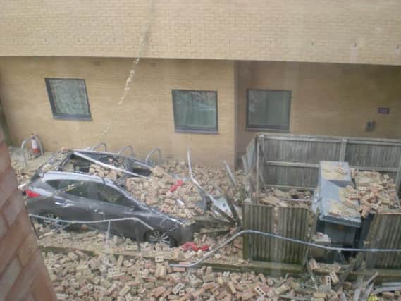 Car destroyed by bricks falling from the Premier Inn in Eastbourne . Photo by Jean Haddow.