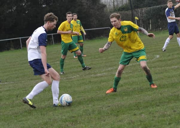 Westfield midfielder Zac Hurst closes down an Upper Beeding opponent. Picture by Simon Newstead (SUS-160602-211419002)