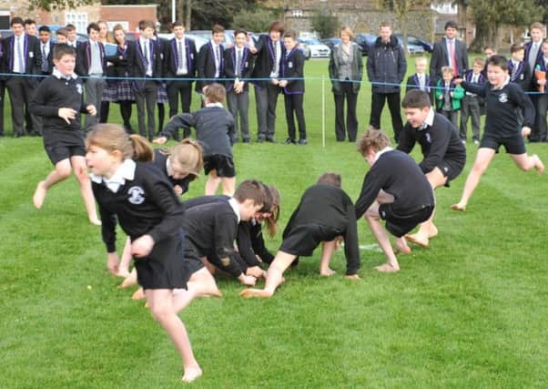 Teams of four year-five pupils scramble for the pancake