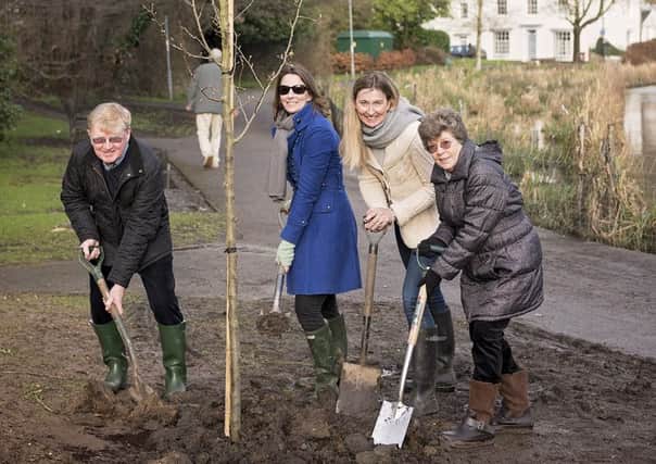 David Duncan planted a tree on Friday in Trinas memory close to the banks of South Pond.  Helping him are his sister Elspeth and Trinas daughters Emma and Nicci                                              PICTURE BY JOANNA CLEEVE