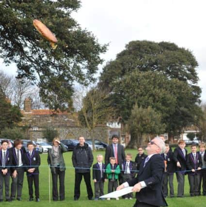 Head teacher Richard Taylor-West throws the 18in pancake into the air