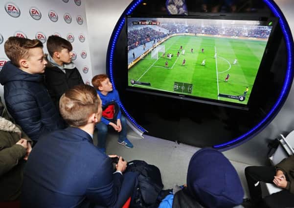 Young Pompey fans play EA Sports Fifa 16 at Fratton Park. Picture: Joe Pepler