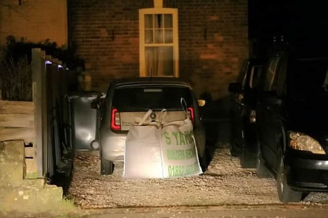 An angry resident placed a tonne of gravel behind a commuter's car after he parked in her private driveway. Photo courtesy of SWNS. SUS-160215-094142001