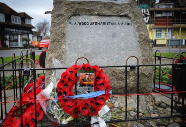 Wreath and flowers at Little Common war memorial in memory of Private Robert Wood, The Royal Logistic Corps, who died in service on 14/2/2011. SUS-160217-145310001