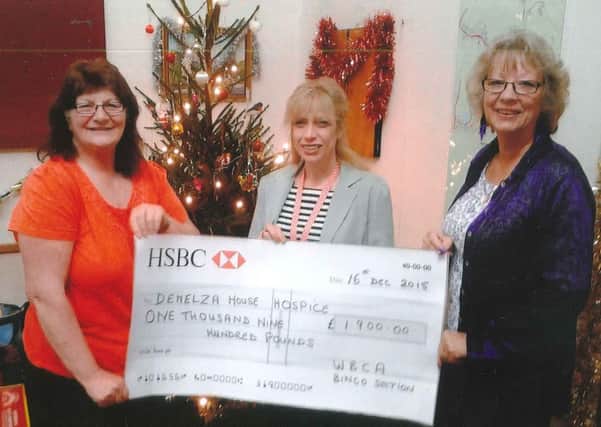 The Winchelsea Beach Community Association Bingo Section presents a cheque to Demelza House Hospice