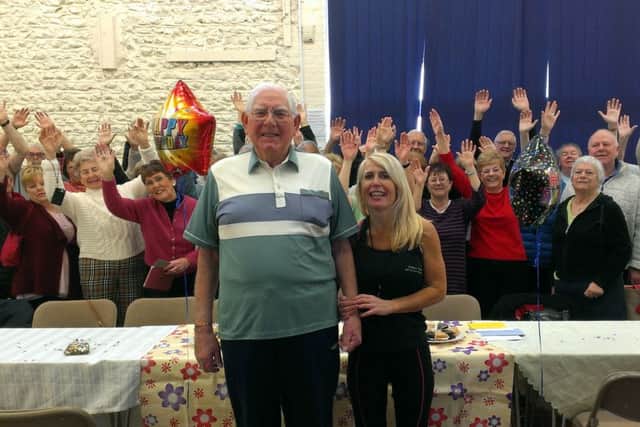 Fergus Hart with Sarah Sampson and fitness class friends celebrating his 91st birthday at East Preston and Kingston Village Hall