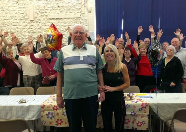 Fergus Hart with Sarah Sampson and fitness class friends celebrating his 91st birthday at East Preston and Kingston Village Hall