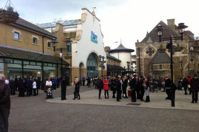 Shoppers outside Priory Meadow Shopping Centre after it was evacuated. Photo by Nikki Dennis