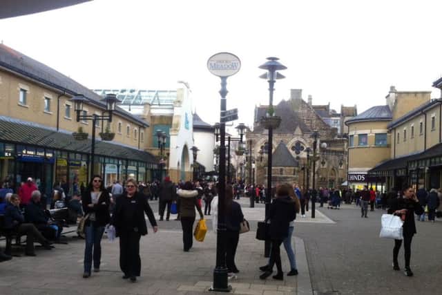 Shoppers outside Priory Meadow Shopping Centre after it was evacuated. Photo by Nikki Dennis