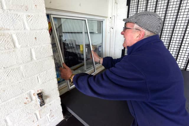 Peacehaven FC break in.
Bob Juden, general manager, fixing damaged window. SUS-160217-225355008