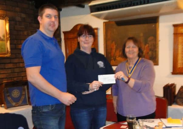 President Liz Box presents the Â£300 cheque to Sharon Penfold and Gary Baines from Shoreham Fort