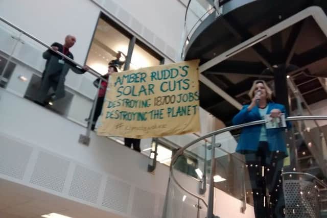 The Combe Haven Defenders' banner behind Amber Rudd at the jobs fair. Photo courtesy of Combe Haven Defenders