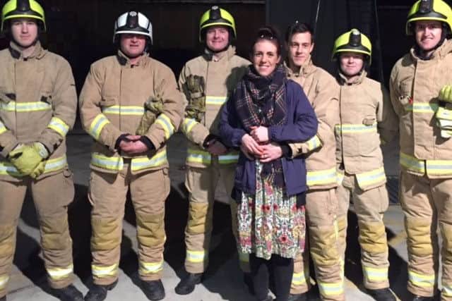Sarah and Kieran pictured with Kieran's colleagues at the fire station