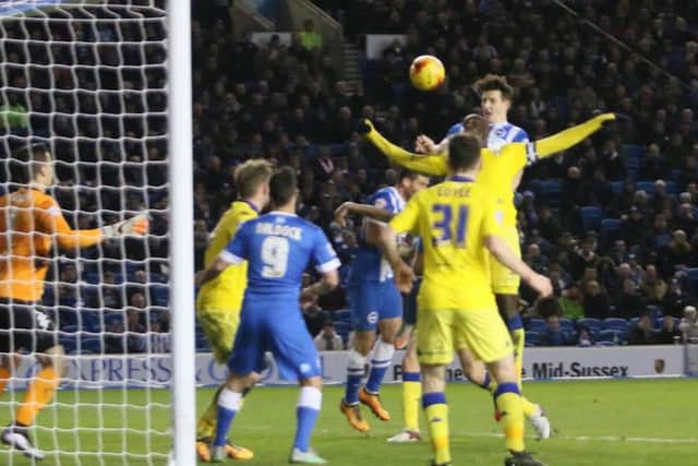 Lewis Dunk heads home Albion's fourth. By Angela Brinkhurst