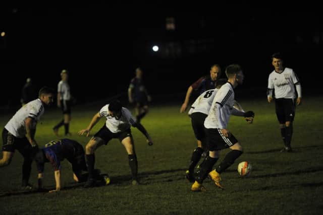 Bexhill United and Langney Wanderers battle it out at The Polegrove on Tuesday night. Picture by Simon Newstead