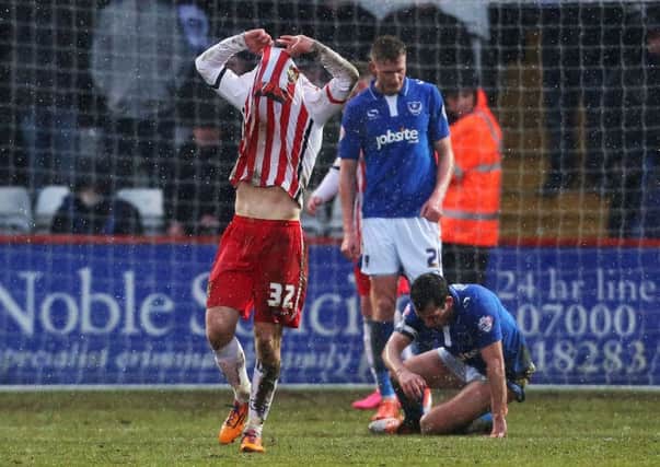 Stevenage midfielder Tom Conlon buries his head in his shirt after seeing his shot hit the crossbar in stoppage-time during his side's 2-0 loss to Pompey   Picture: Joe Pepler